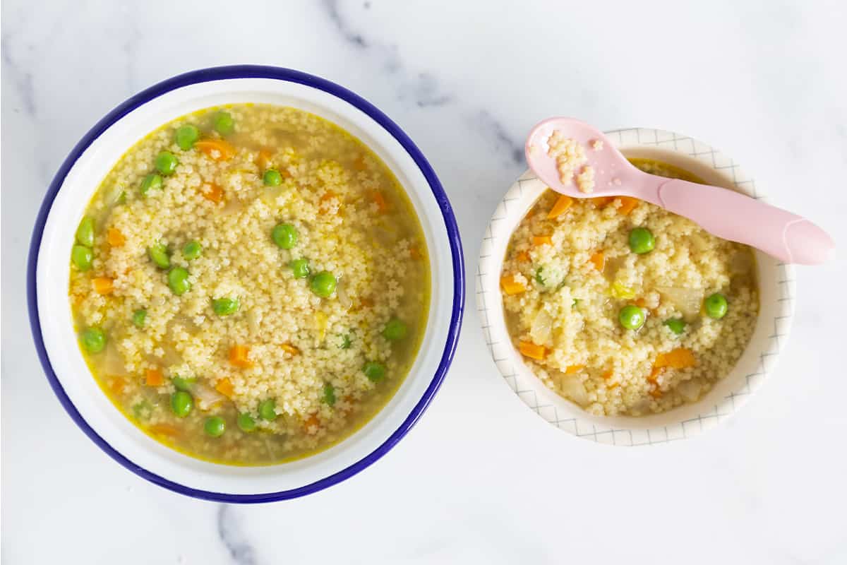 Pastina soup in two bowls with spoons.