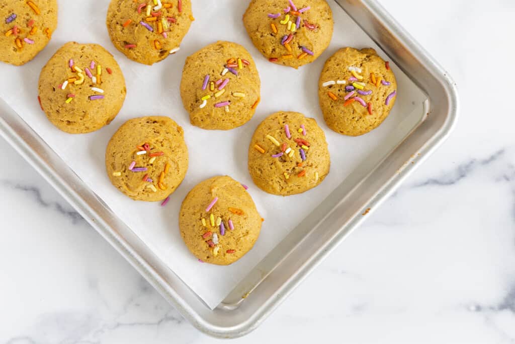 Pumpkin cookies on baking sheet after baking.