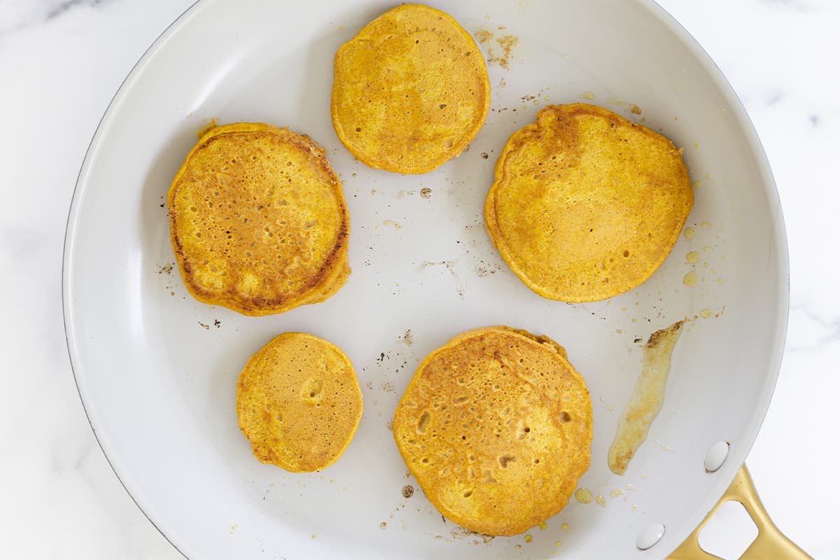 pumpkin pancakes in pan after cooking.