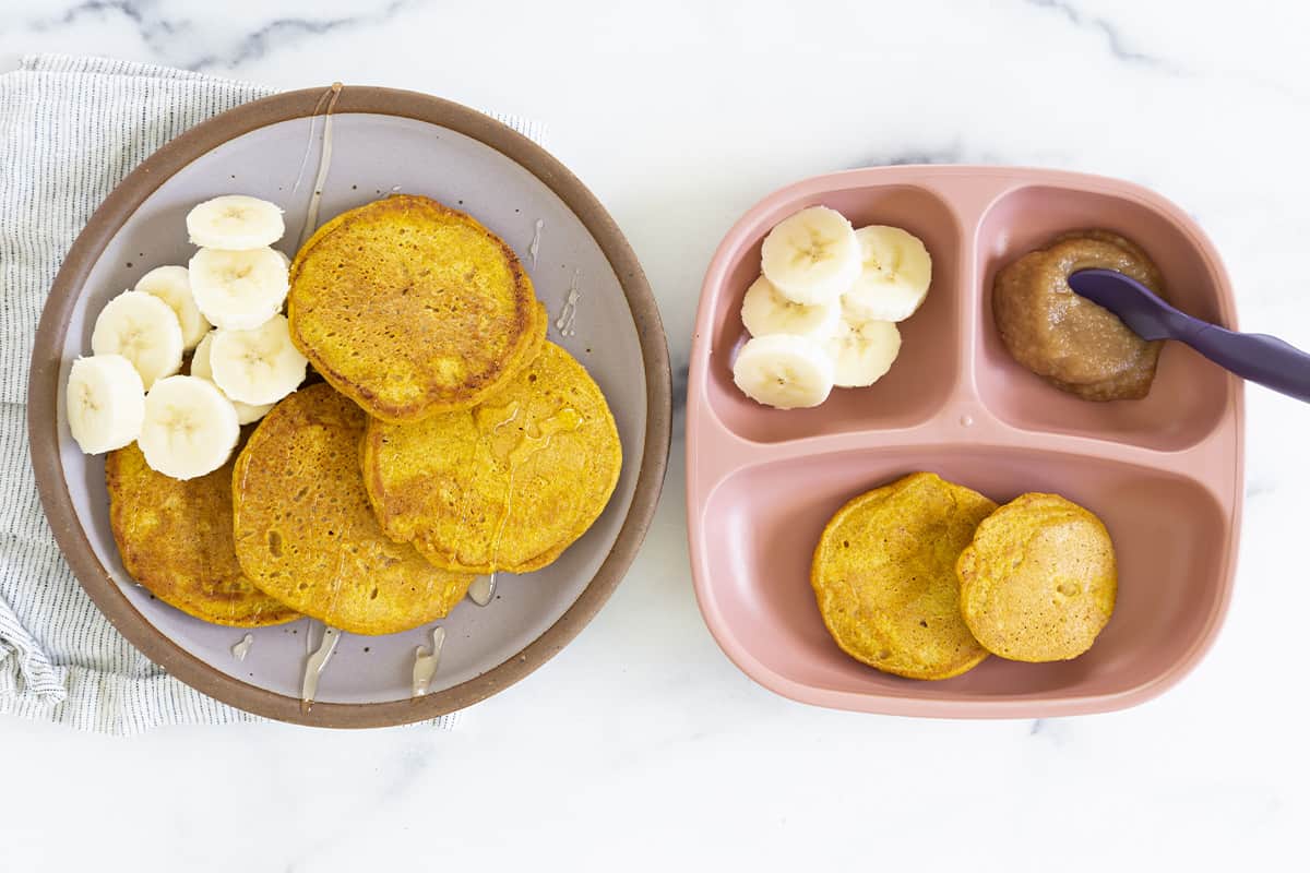 pumpkin pancakes on two plates with banana slices