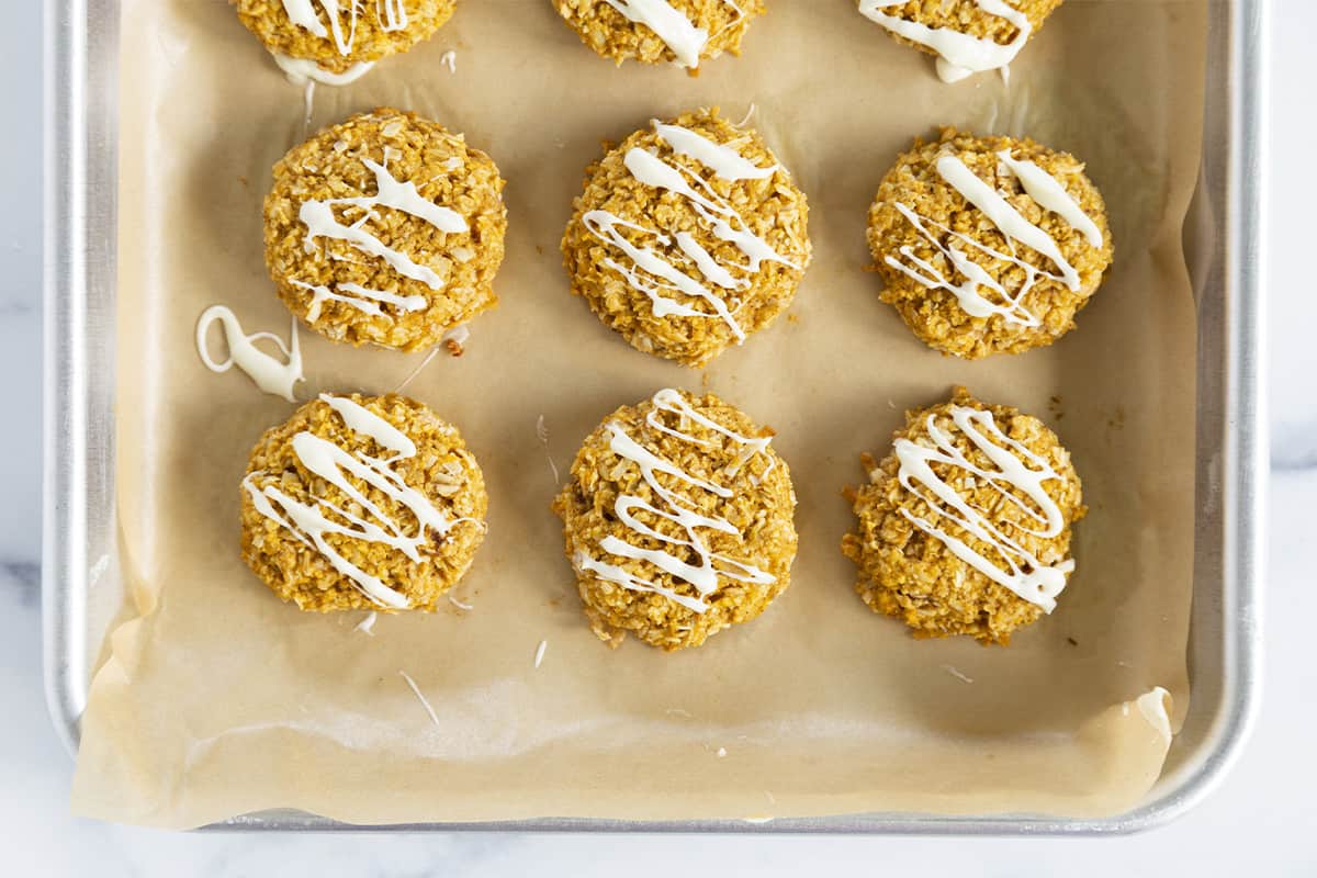 sweet potato cookies with icing on baking tray.