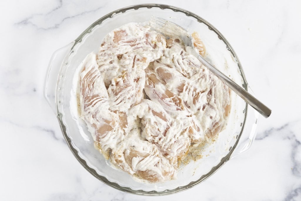 Yogurt chicken in glass bowl.