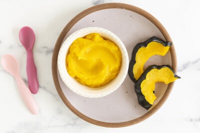 Acorn squash as puree and slices on plate.