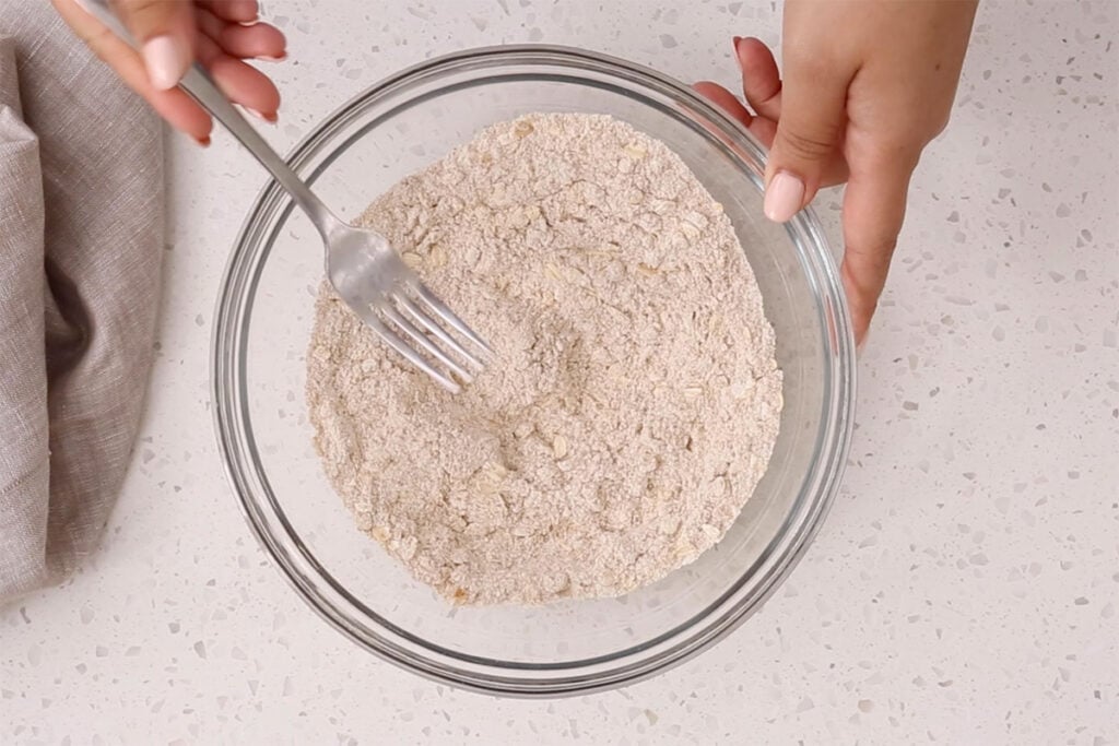 mixing apple pancake batter in bowl.