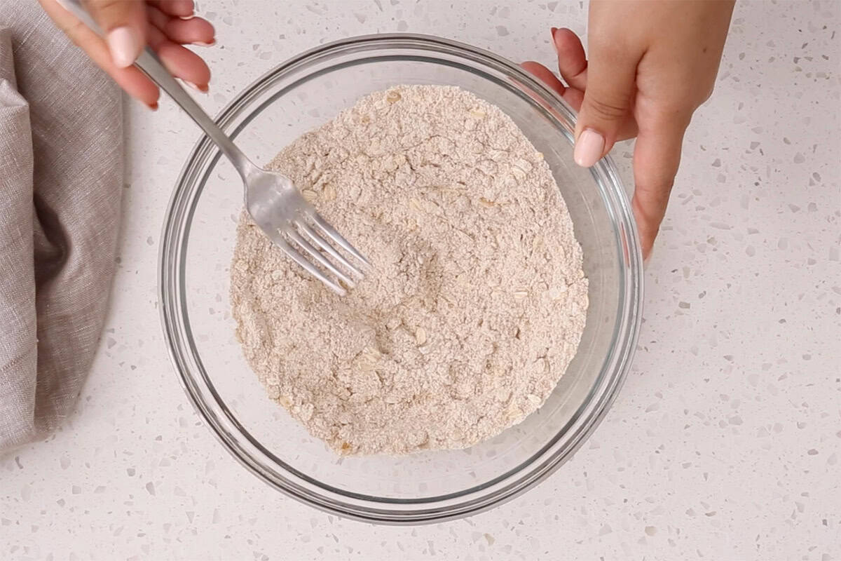 mixing apple pancake batter in bowl.