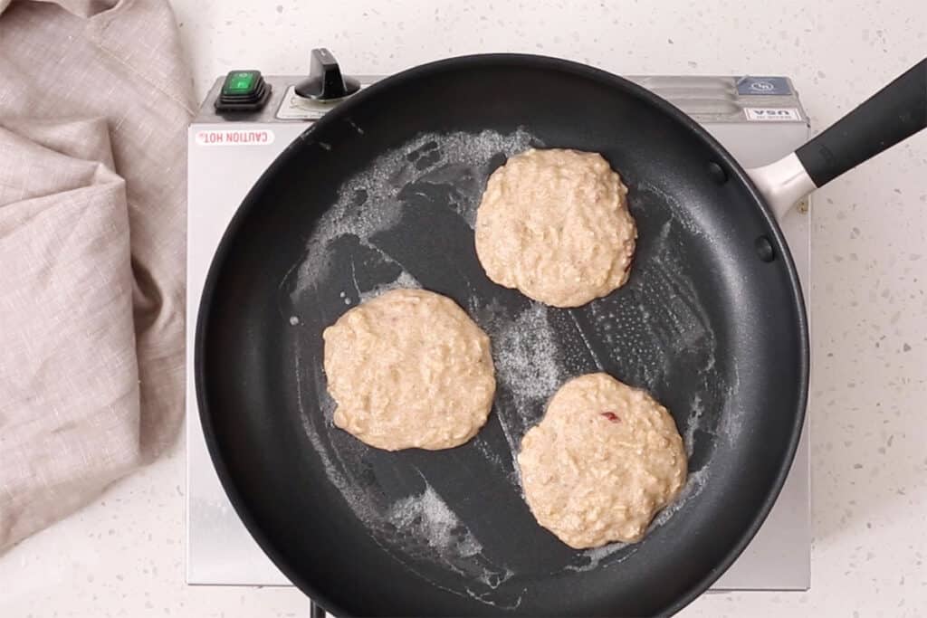 cooking apple pancakes in pan.
