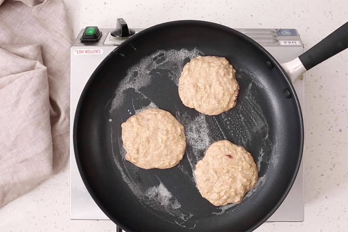 cooking apple pancakes in pan.