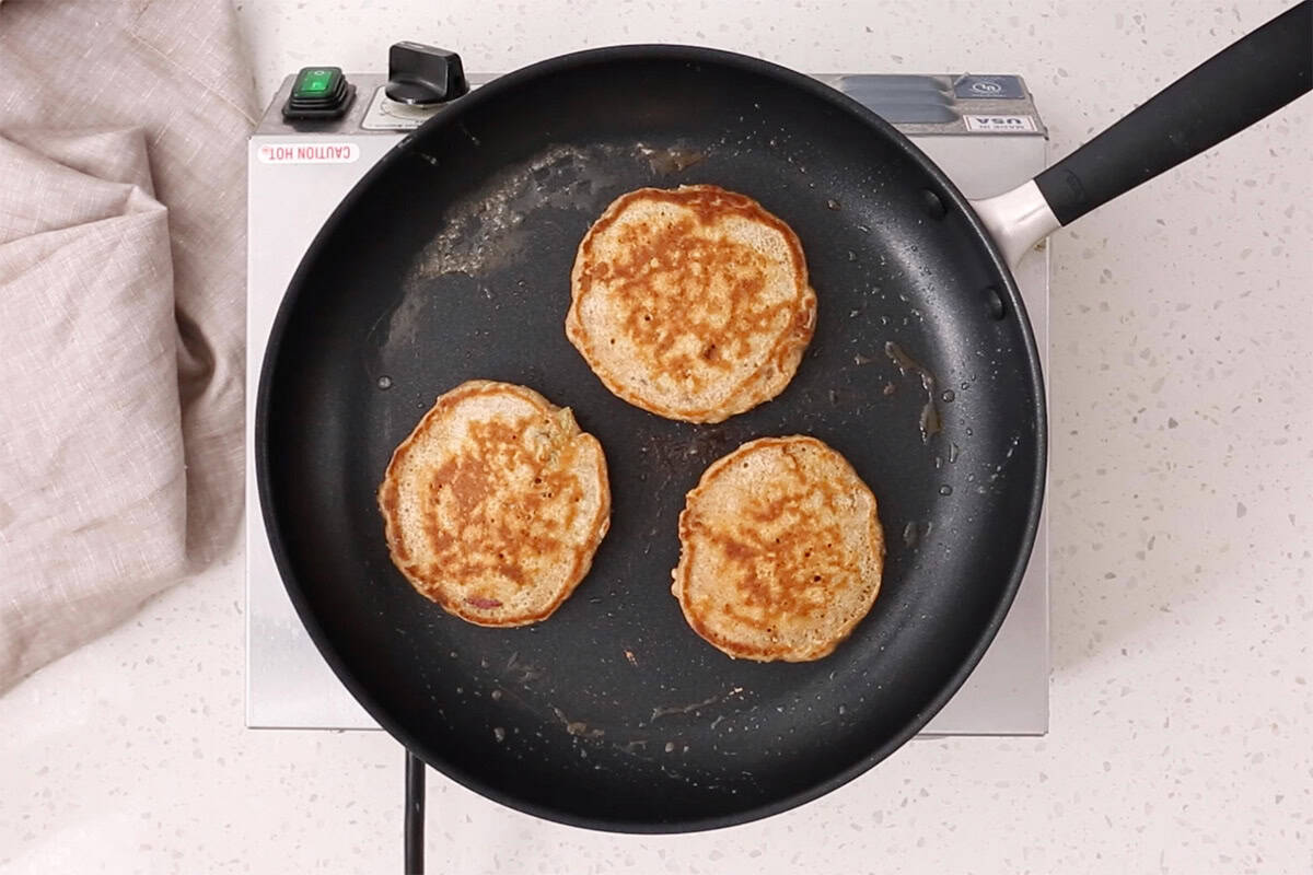 cooked apple pancakes in pan.