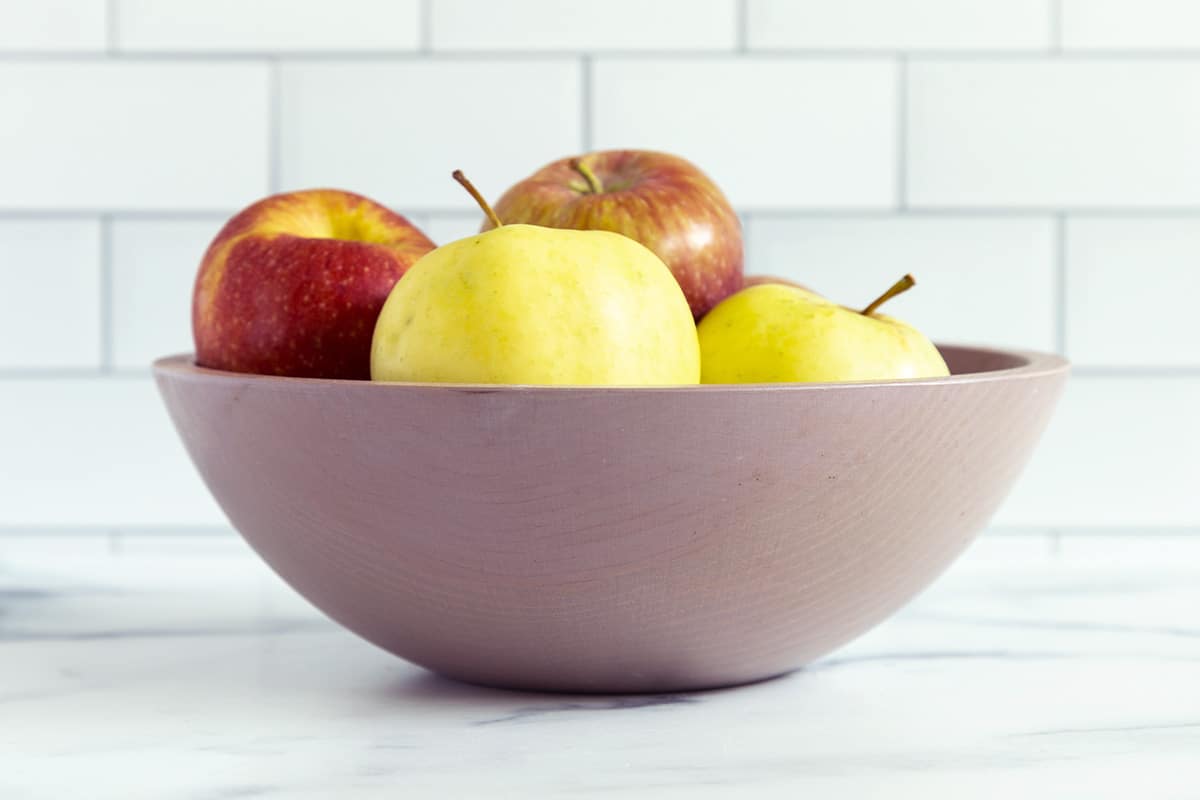 bowl of apples on countertop.
