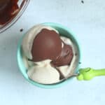 banana ice cream with magic shell in teal bowl.