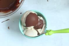 banana ice cream with magic shell in teal bowl.