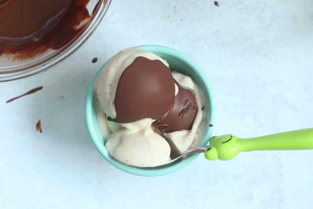 banana ice cream with magic shell in teal bowl.