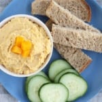 butternut squash hummus in white bowl with dippers.