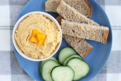 butternut squash hummus in white bowl with dippers.