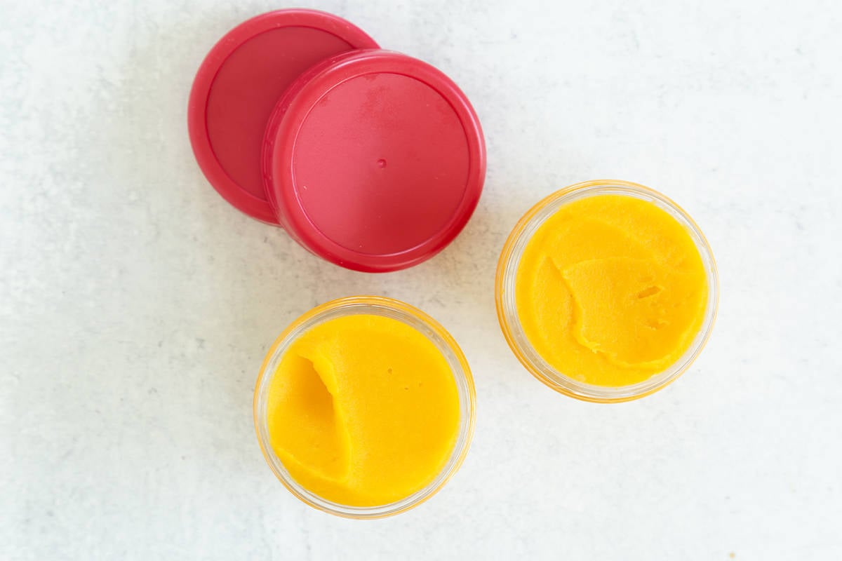 Butternut squash baby food in two glass jars.