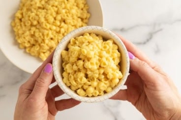 Butternut squash mac and cheese in white bowl.