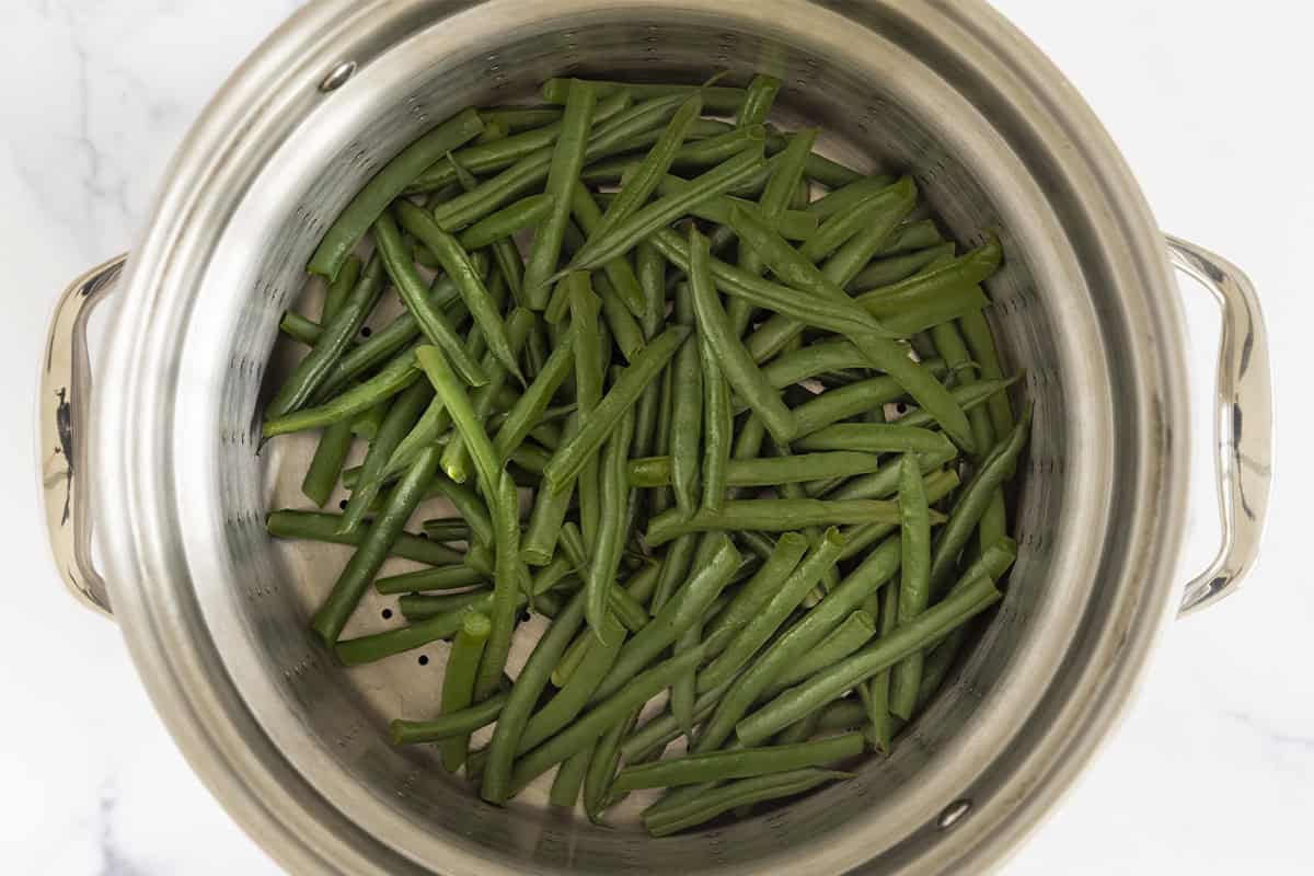 Green beans in pot of water.