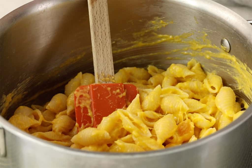 butternut squash mac and cheese in pot with spoon.