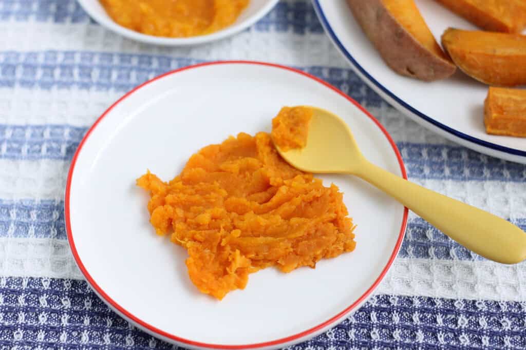 mashed sweet potato on white plate.
