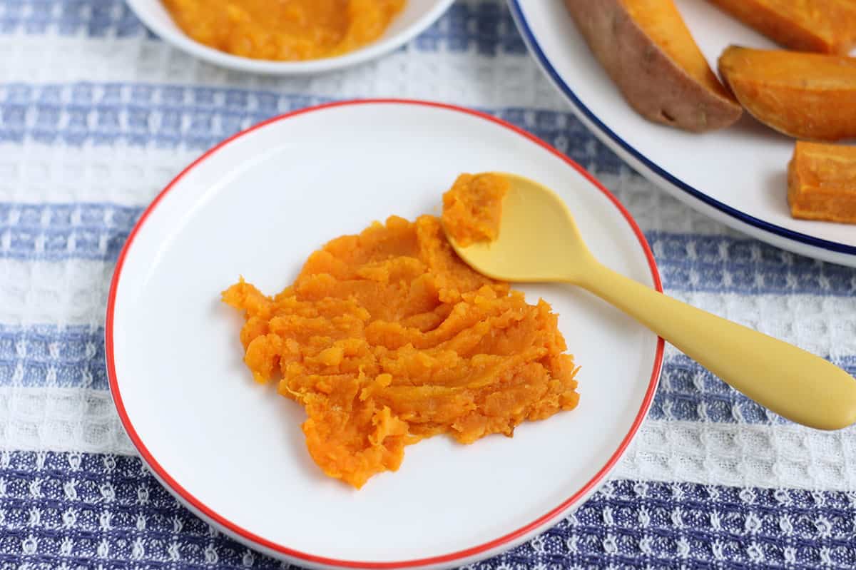 mashed sweet potato on white plate.