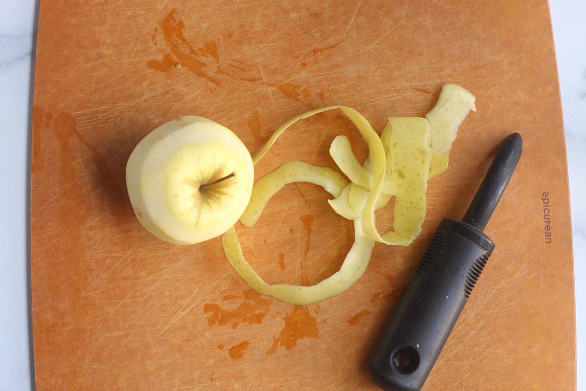 peeling apples on cutting board.