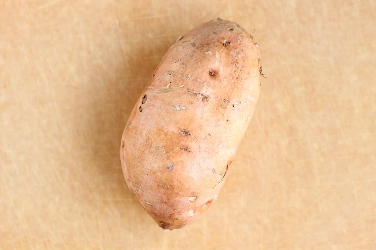 sweet potato on cutting board.