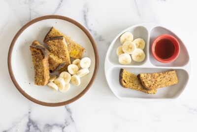 Air Fryer French Toast and adult and kids plates with bananas and syrup.