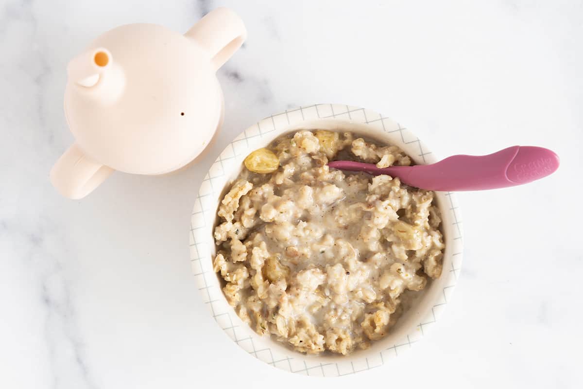 Oatmeal in bowl with spoon for baby breakfast ideas.