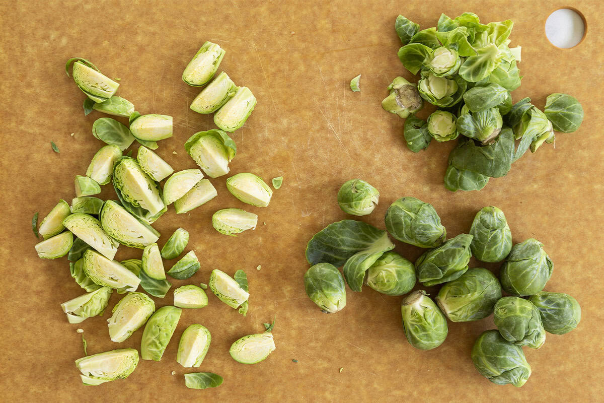 Brussel sprouts being cut on cutting board for puree. 