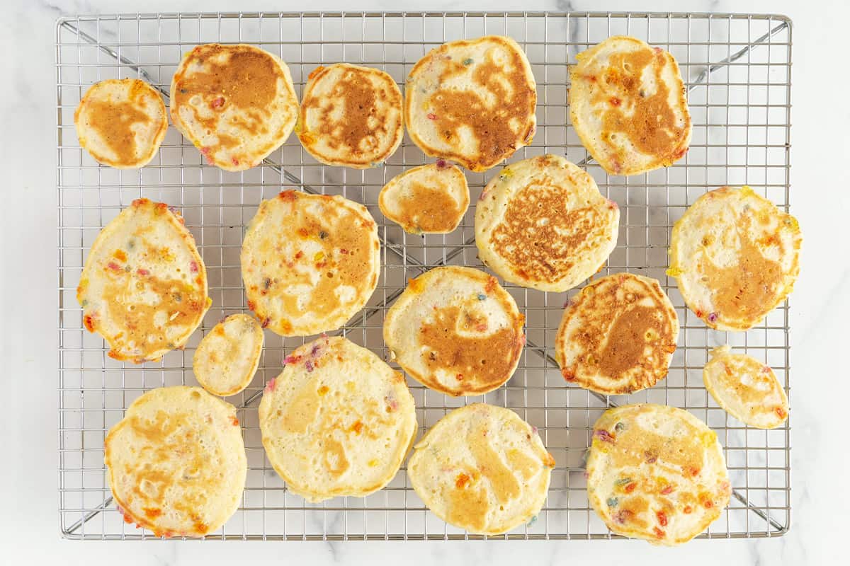 Funfetti pancakes on cooling rack.
