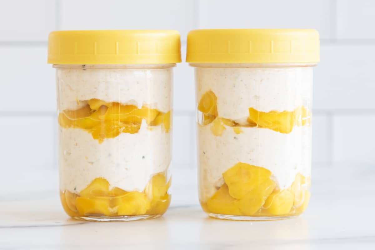 overnight oats with greek yogurt in jars on counter.