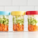 Mirepoix in three glass jars on countertop.