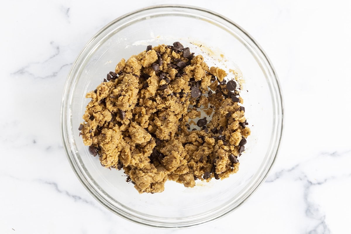 Batter for dairy free chocolate chip cookies in glass bowl.