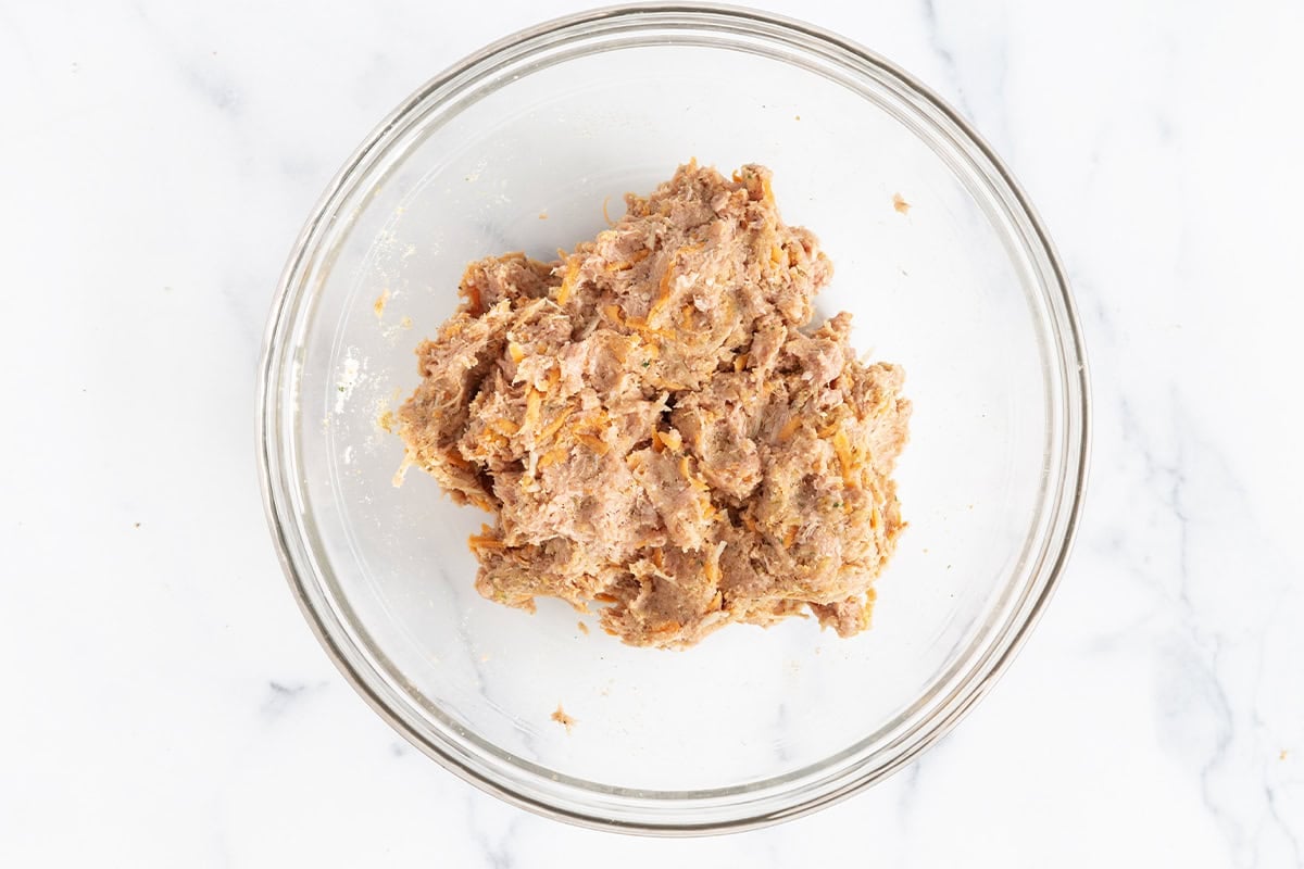 Mixture for turkey sweet potato meatballs in glass bowl.