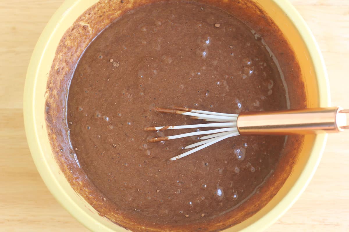 healthy chocolate cake batter in yellow bowl.