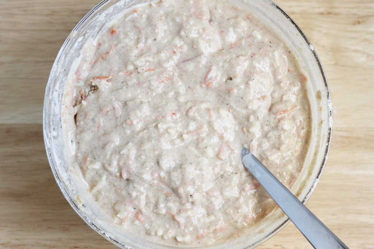 pizza muffins batter with wet and dry ingredients in bowl.