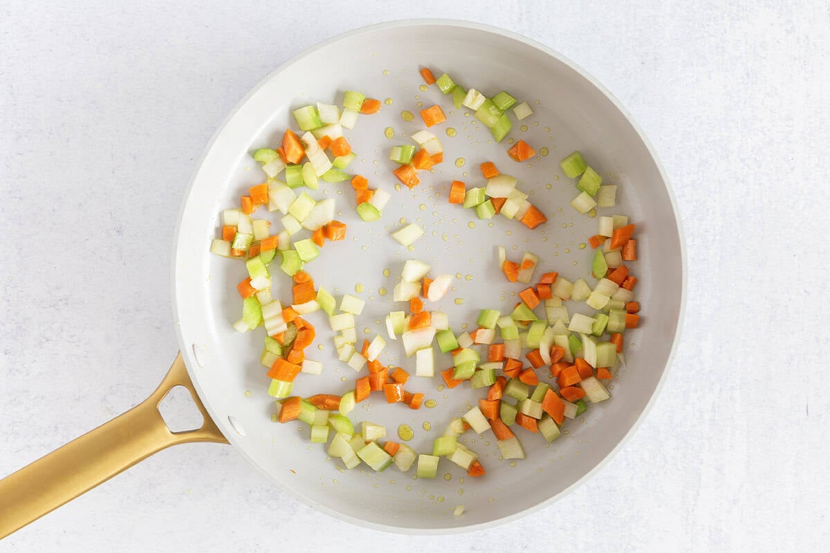 Chopped veggies in pan for ground beef pasta.