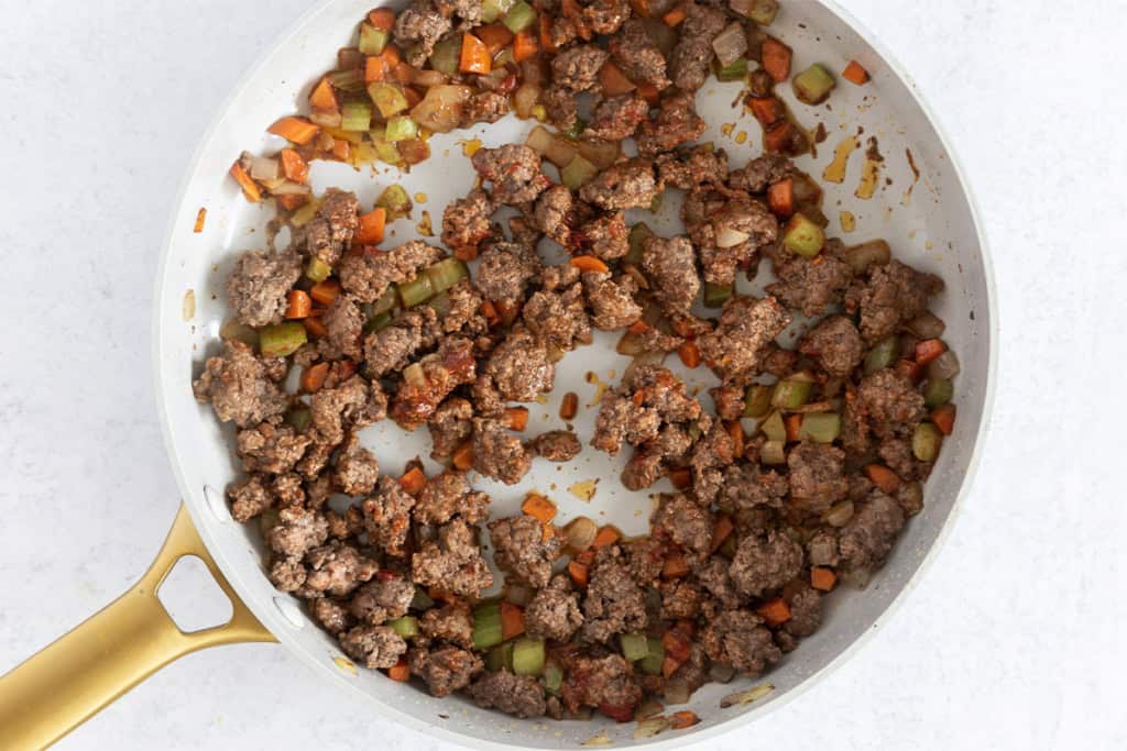 Veggies and ground beef in pan for pasta.