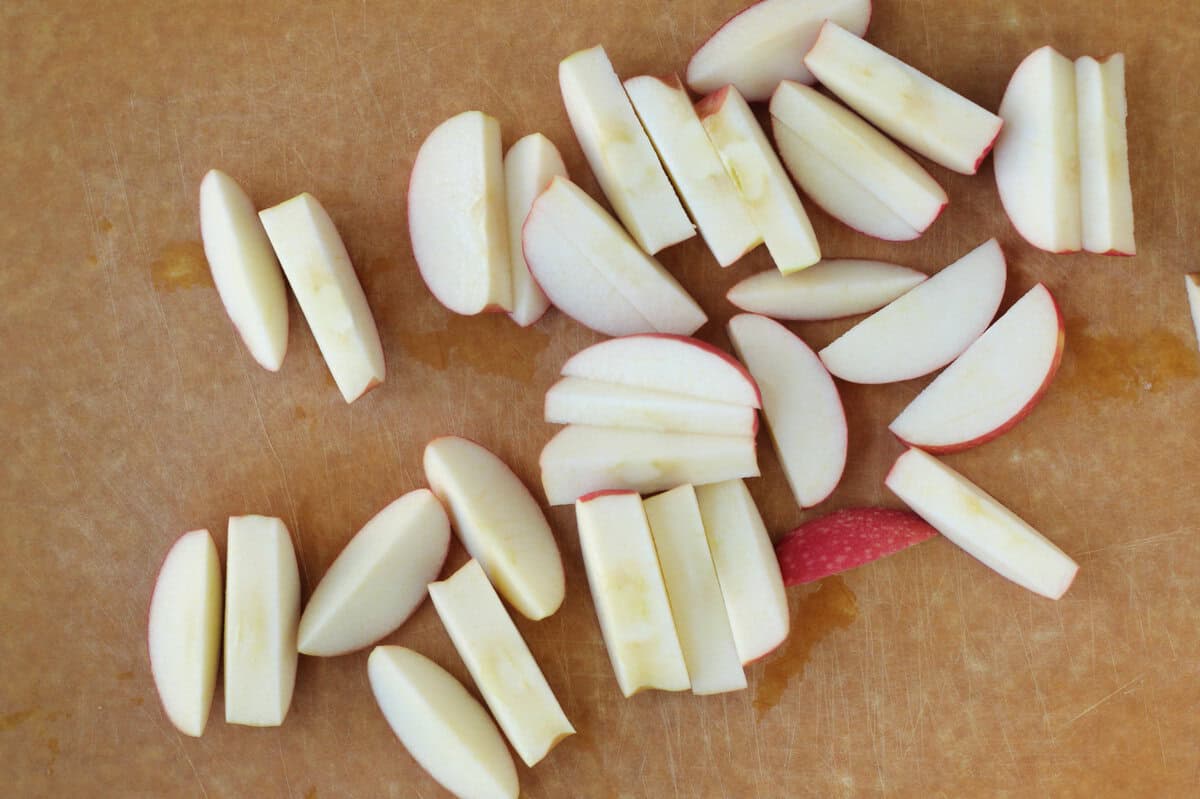 Cutting apples on cutting board for baked apples.
