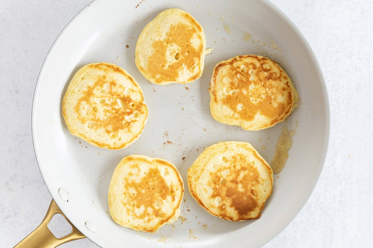 cooked Greek yogurt pancakes in skillet.