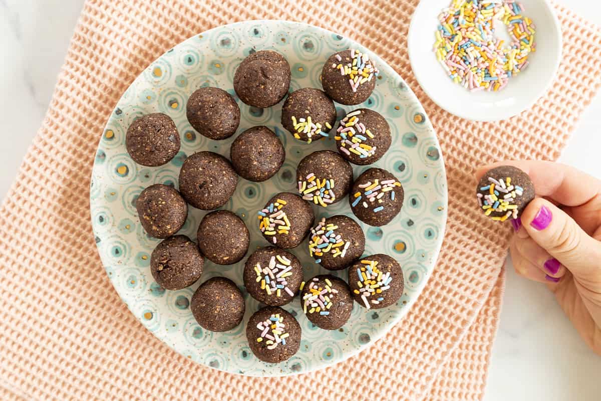 chocolate balls on plate with sprinkles.