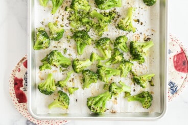 Roasted frozen broccoli on pan.