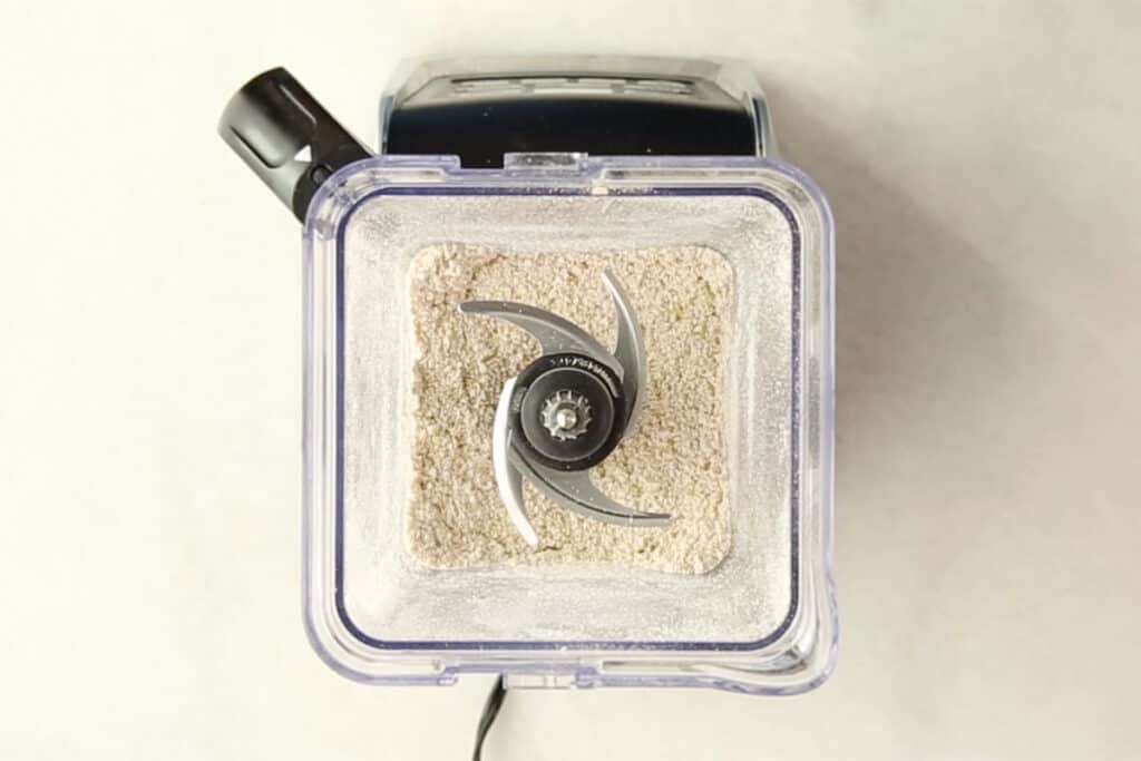 grinding oats in blender for banana oatmeal muffins.