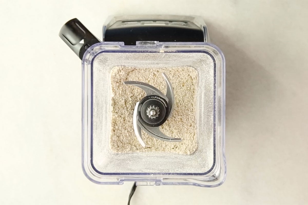grinding oats in blender for banana oatmeal muffins.