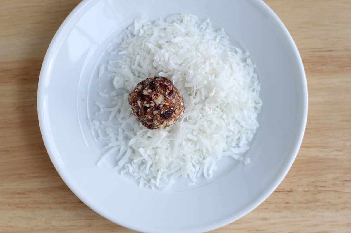 rolling energy bites in coconut.