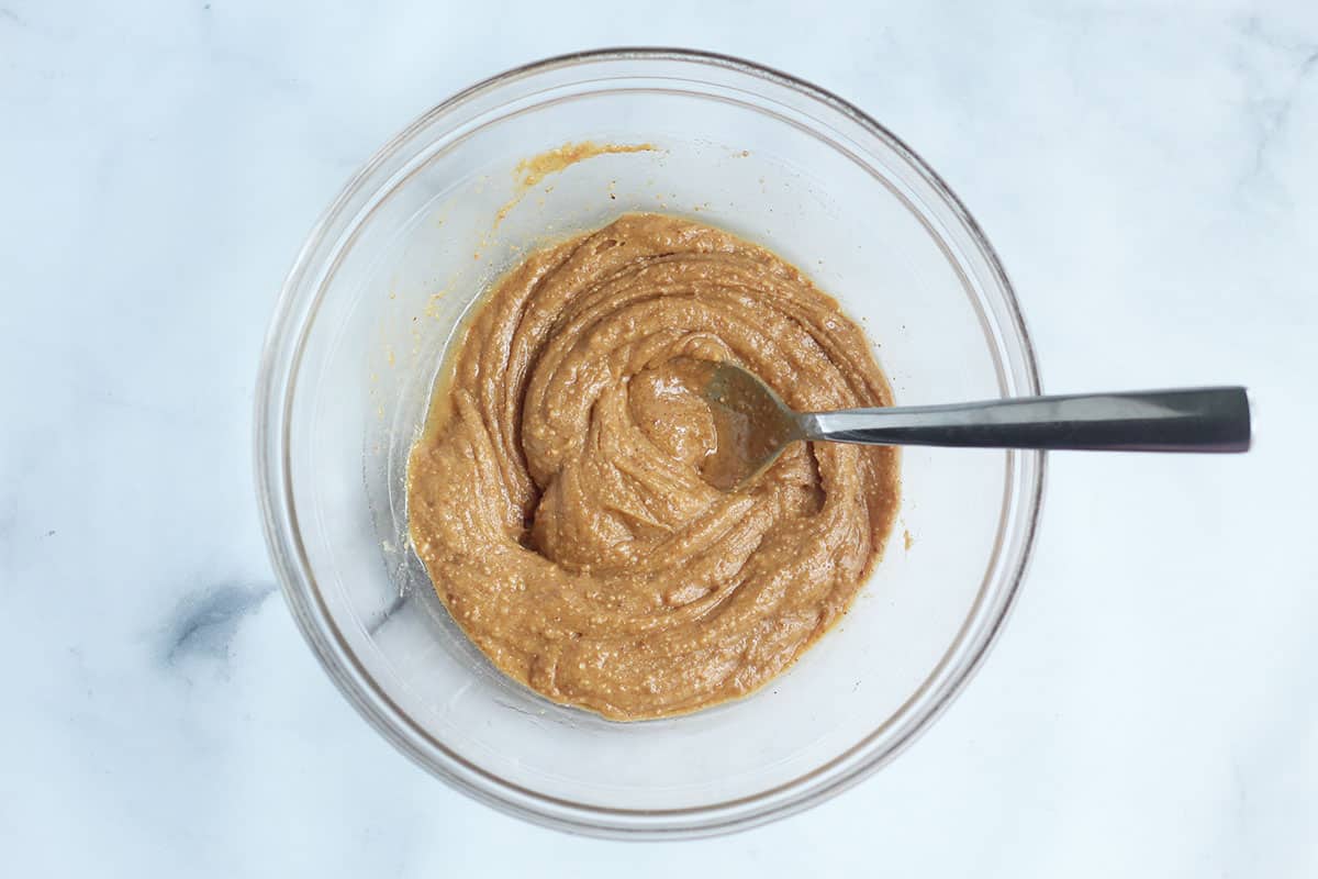 peanut butter and honey in glass bowl on counter.