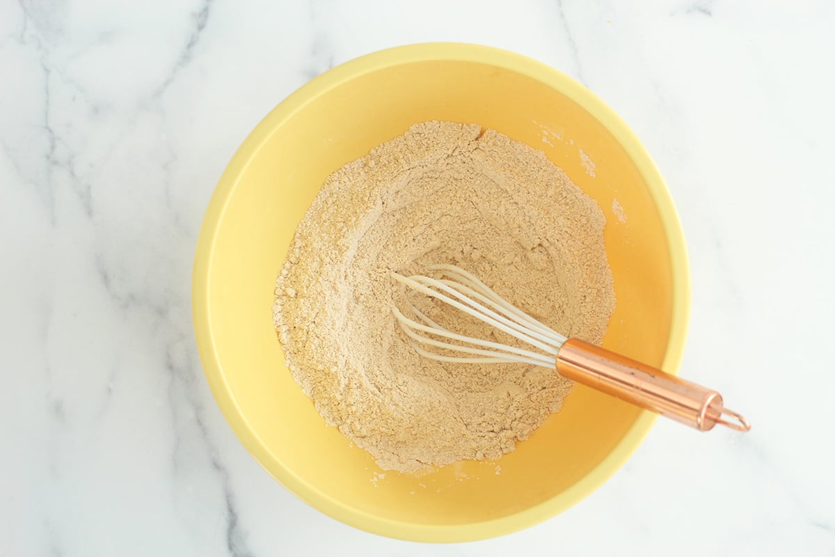 dry ingredients for pancake muffins in yellow bowl.