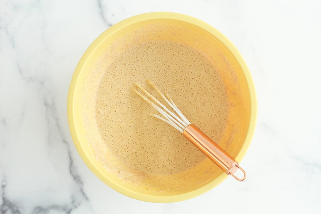 wet batter for pancake muffins in yellow bowl.