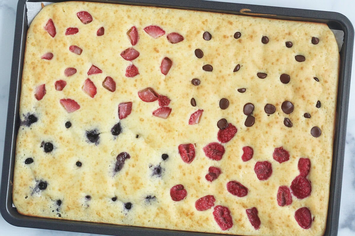 sheet pan yogurt pancake with fruit on top.