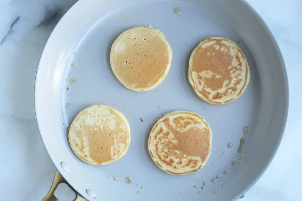 golden brown yogurt pancakes in pan on counter.